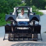 skid steer grapple rake on a skid steer