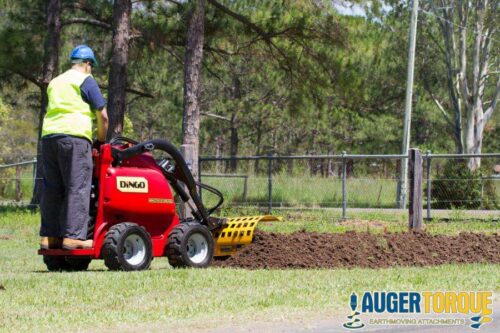 mini skid steer trencher digging trench