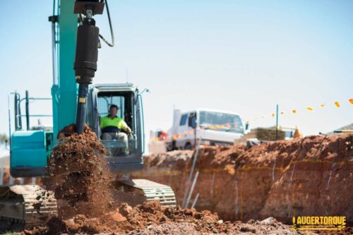 large excavator auger drilling holes